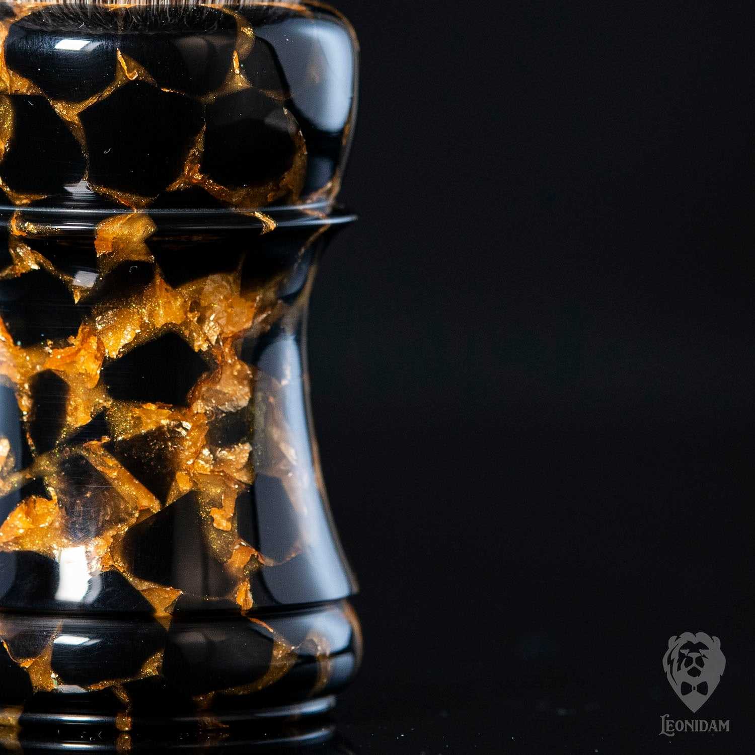 Closeup of Handmade Shaving Brush "Anubis" in polished black and gold resin.